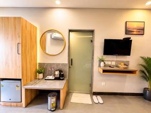 a room with a desk and a tv and a mirror at Hotel Prabhu Pada Puri - Beach Front Hotel With Swimming Pool And Restaurant - SPA- Banquet - Parking Facility in Puri
