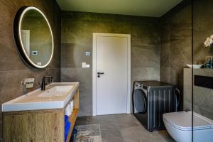 a bathroom with a sink toilet and a mirror at Victory port Apartmán in Liptovský Mikuláš +27 photos