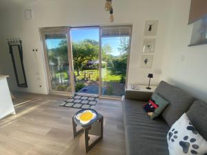 a living room with a couch and a large window at Tiny House 47 in Egloffstein