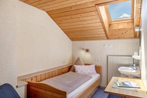 a small room with a bed and a sink at Ferienwohnung Panorama Bad Kohlgrub in Bad Kohlgrub