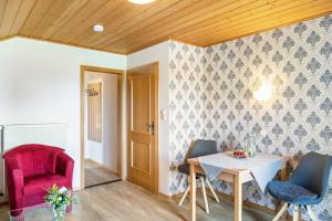 a dining room with a table and two chairs at Ferienwohnung Panorama Bad Kohlgrub in Bad Kohlgrub