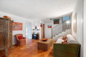 a living room with a couch and chairs and a staircase at Villa Sardinia Costa Smeralda in Arzachena