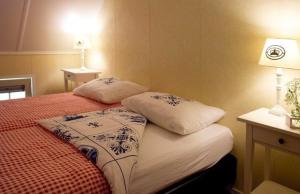 a bedroom with a bed with two pillows on it at Erve Woolderink in Wierden