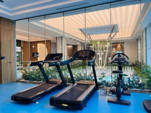 a gym with two tread machines in a building at Grand Hotel President in Baile Felix