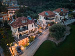 an overhead view of a large house with lights at Nest In The Yard in Parga