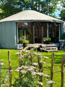 a gazebo in a yard with flowers at Harresø Haves Jurt in Give