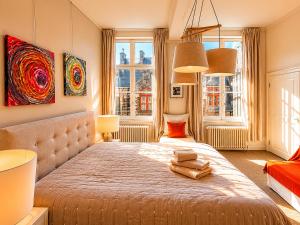 a bedroom with a large bed with two towels on it at Villa Theresa à 25 min de PAIRI DAIZA in Soignies +26 photos