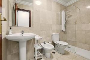 a bathroom with a sink and a toilet and a mirror at NG CANDELARIA - Tenerife in Candelaria +26 photos