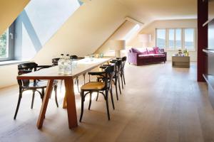 a dining room with a table and chairs at Studios & Spa Suites Rigiblick in Zurich