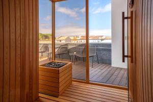 a balcony with a view of a table and chairs at The Book Hotel in Horta
