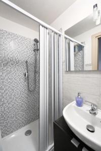 a bathroom with a sink and a shower at Blue Sky House in Taormina