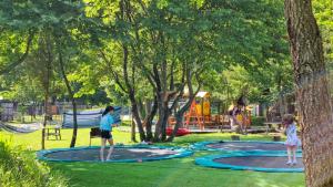 two girls playing on trampols in a park at Ninemia Stay and Play in Karpenisi