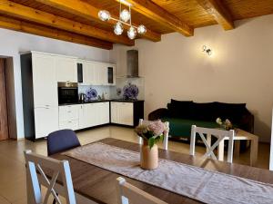 a kitchen and living room with a table and a couch at Pod skrzydłami IV in Miłomłyn +14 photos