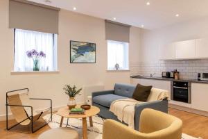 a living room with a couch and a table at Cove Minshull Street in Manchester