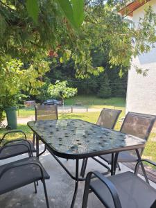 a table and chairs sitting on a patio at Apartmani Natura SH in Hodžinac