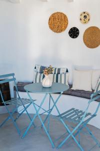 a blue table and two chairs in a living room at The Windmill Serifos in Serifos Chora