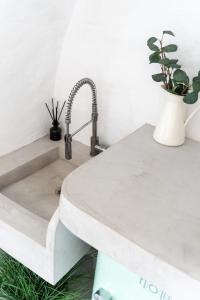 a kitchen sink with a concrete counter top at The Windmill Serifos in Serifos Chora