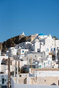 a group of white buildings on top of a hill at The Windmill Serifos in Serifos Chora