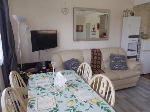 a living room with a table and chairs and a couch at SHORTIEs STAYS in Hemsby