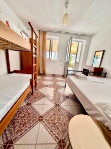 a bedroom with two bunk beds and a tiled floor at Tony Home in Borsh