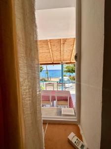 a room with a view of the beach through a window at Tony Home in Borsh +92 photos