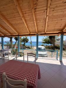a table and chairs on a porch with the ocean at Tony Home in Borsh