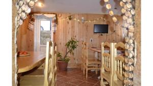 a dining room with a wooden table and chairs at Садиба Хатинка у Люби in Yaremche