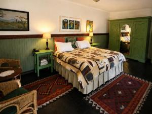 a bedroom with a large bed and green cabinets at Quiet Mountain Country House in Hekpoort