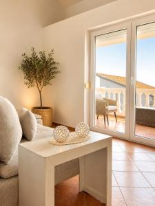 a living room with a couch and a table at Apartments Villa Klaudia in Crikvenica