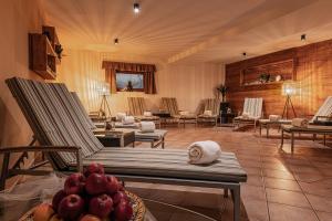 a living room with chairs and a table with fruit at Crëp Sella in Colfosco