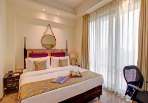 a hotel room with a large bed and a mirror at Rhythm Gurugram, Hotel & Suites, Sohna Road, Sector 68 in Gurgaon
