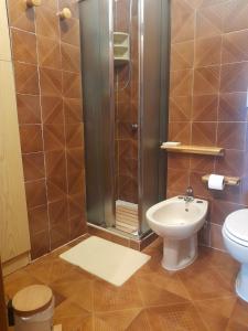a bathroom with a shower and a toilet and a sink at Diana Apartment Savona in Savona +14 photos