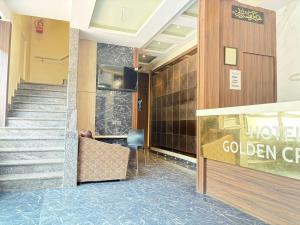 a lobby of a hotel with a golden gate sign at Hotel Golden Crown in Mumbai
