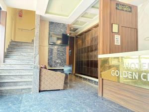 a lobby of a hotel with stairs and a welcome sign at Hotel Golden Crown in Mumbai