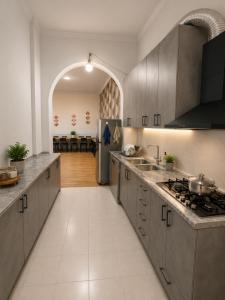 a kitchen with gray cabinets and a refrigerator at Dreamers Hostel & Hotel Apartment in Yerevan