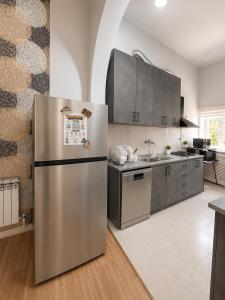 a kitchen with a stainless steel refrigerator at Dreamers Hostel & Hotel Apartment in Yerevan +25 photos