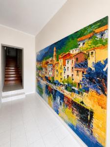 a large painting on a wall in a room at Dreamers Hostel & Hotel Apartment in Yerevan