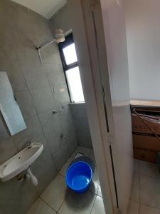 a bathroom with a toilet and a sink and a window at Edwin homes in Nairobi +9 photos