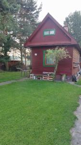 a red barn with a picnic table in front of it at Chatka in Partizánska ľupča