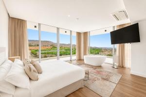 a bedroom with a large white bed and a large window at CHALET 95, Lujo y Piscina Infinity in Adeje