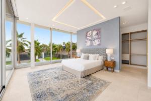 a bedroom with a bed and large windows at CHALET 95, Lujo y Piscina Infinity in Adeje +29 photos