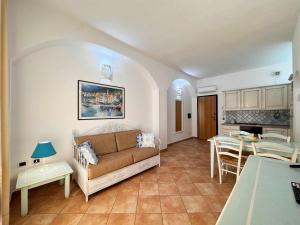 a living room with a couch and a table at Guest House Villabianca in La Maddalena