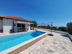 a swimming pool in the backyard of a house at Relax in Orebić
