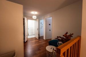 a hallway of a home with a staircase and a living room at Spacious apartment in Talence in Talence