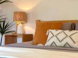 a bedroom with a bed with a pillow and a lamp at Mandala Tribe Treehouses in Siquijor +33 photos