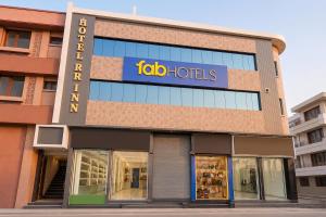 a store front with a sign on the side of it at FabHotel RR Inn in Kānpur