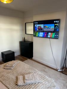 a room with a large screen on the wall at Newly Refurbished House in Norwood +17 photos