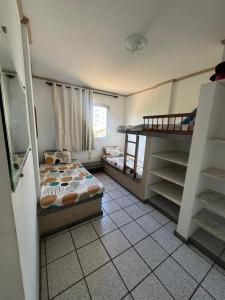 a bedroom with a bed and a bunk bed at Apartamento Castelhanos ES in Anchieta