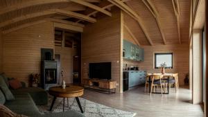 a kitchen and living room with a table and a tv at Zrub Lipa, Tatry, krb a súkromie in Mengusovce
