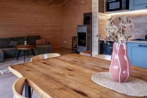 a living room with a wooden table with a vase on it at Zrub Lipa, Tatry, krb a súkromie in Mengusovce